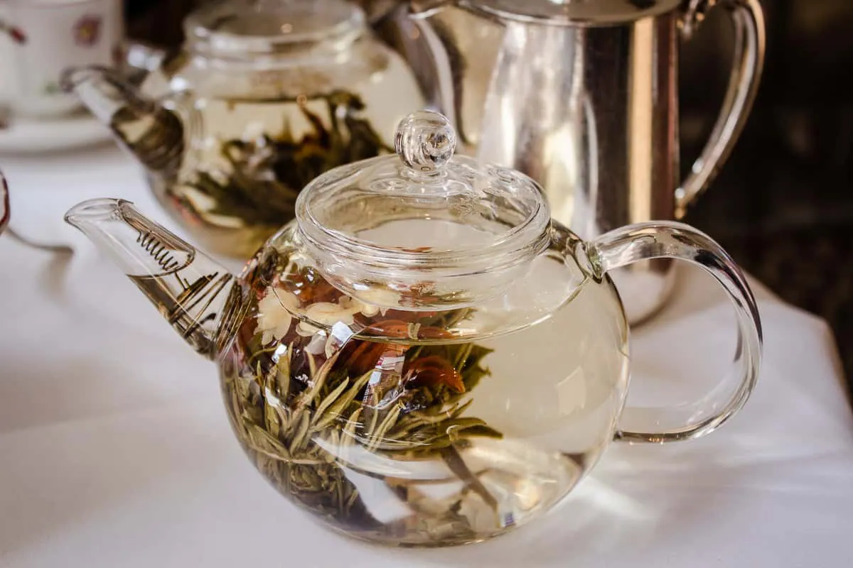 Image shows a glass teapot filled with flowering tea.