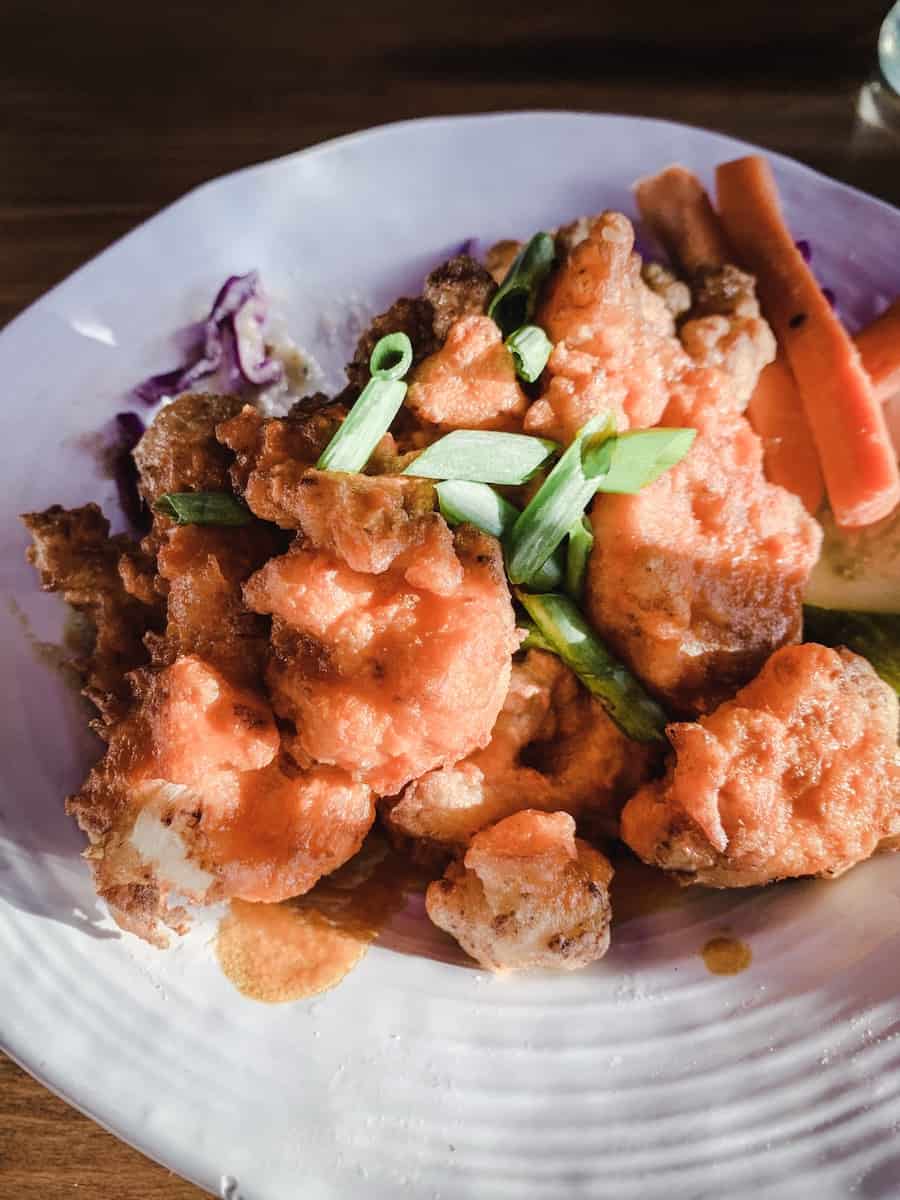 My Favourite Vegan restaurants in Seattle - Vancouver with Love. Image of Buffalo Cauliflower Wings from No Bones Beach Club.