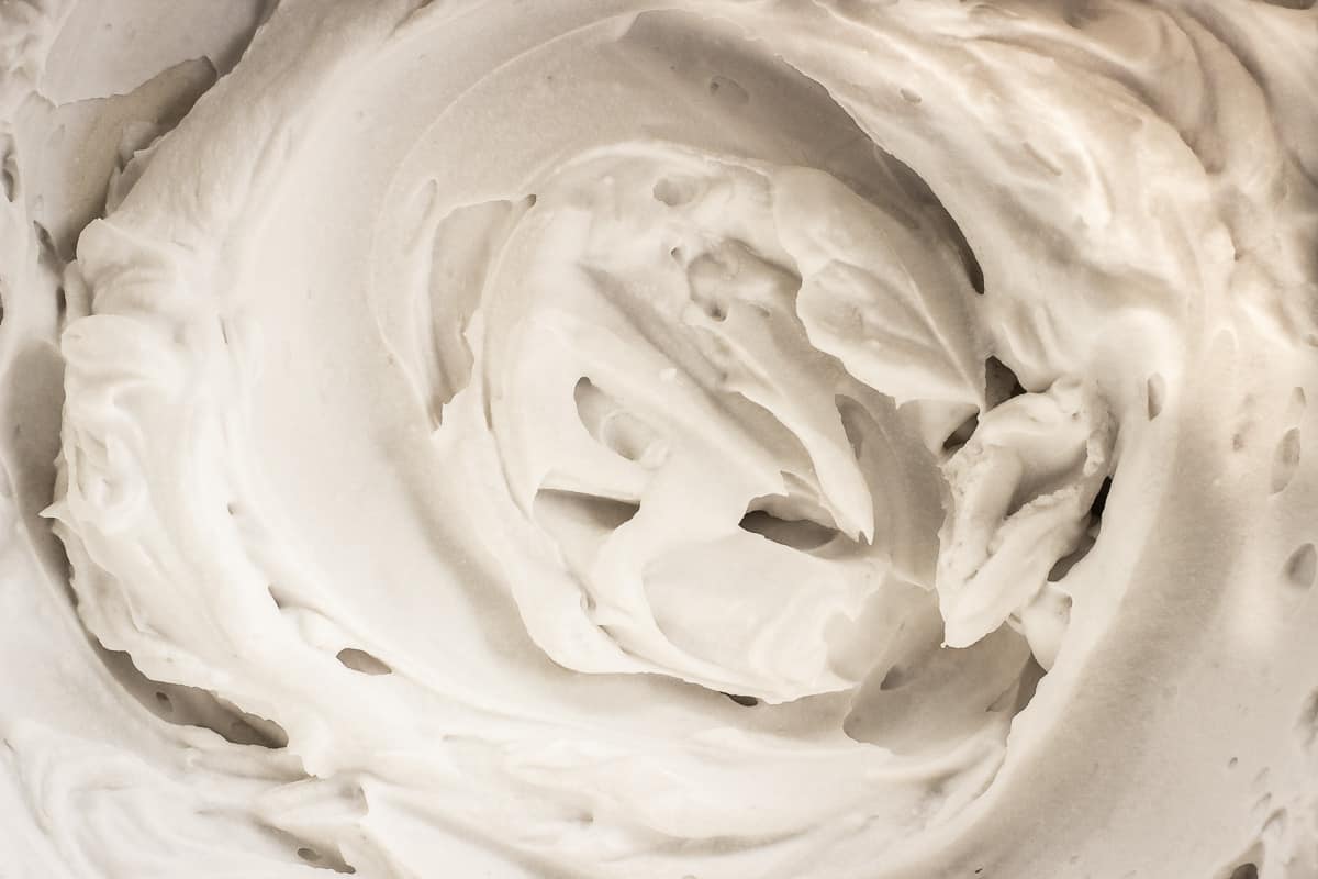Image shows a bowl full of coconut whipped cream.