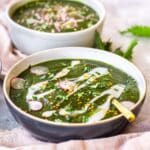 Bowl of Nutrient-Rich Nettle Soup, decorated with cashew cream.