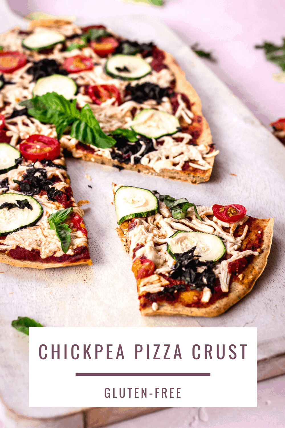 Crispy, gluten-free chickpea flour pizza crust topped with tomato sauce, vegan cheese, zucchini, spinach and basil. A healthier way to enjoy pizza that's also protein-rich. #chickpea #pizza #glutenfree #vegan #healthy #chickpeaflour #vegancheese
