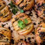 Sage & Garlic Hasselback Potatoes on a baking tray