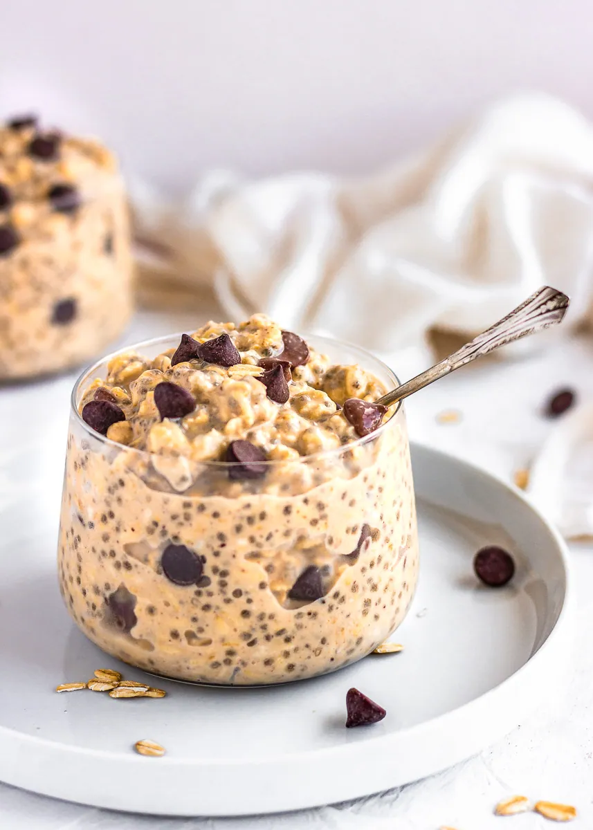 Cookie Dough Overnight Oats in glass jar with a spoon.