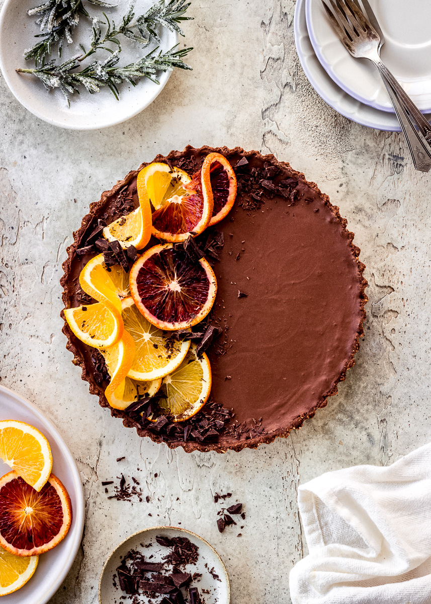 Overhead image of orange chocolate tart made with fresh orange slices and dark chocolate.