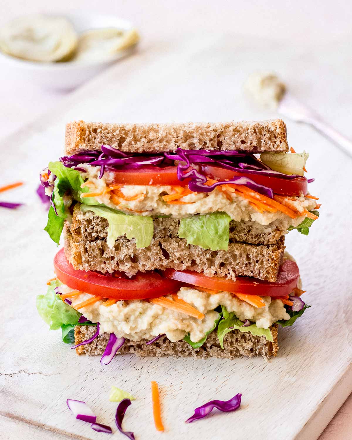 How to go vegan - artichoke and white bean sandwich with fresh vegetables.