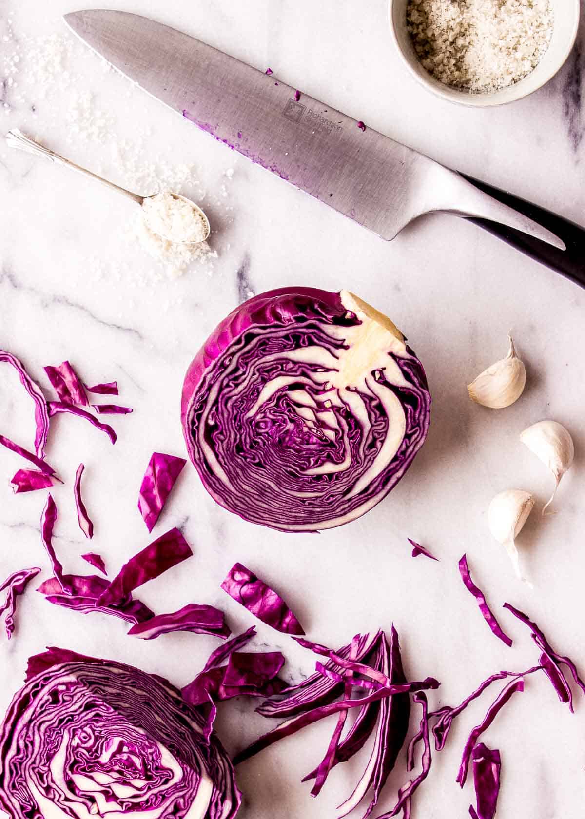 Ingredients for sauerkraut with red cabbage on a marble slab