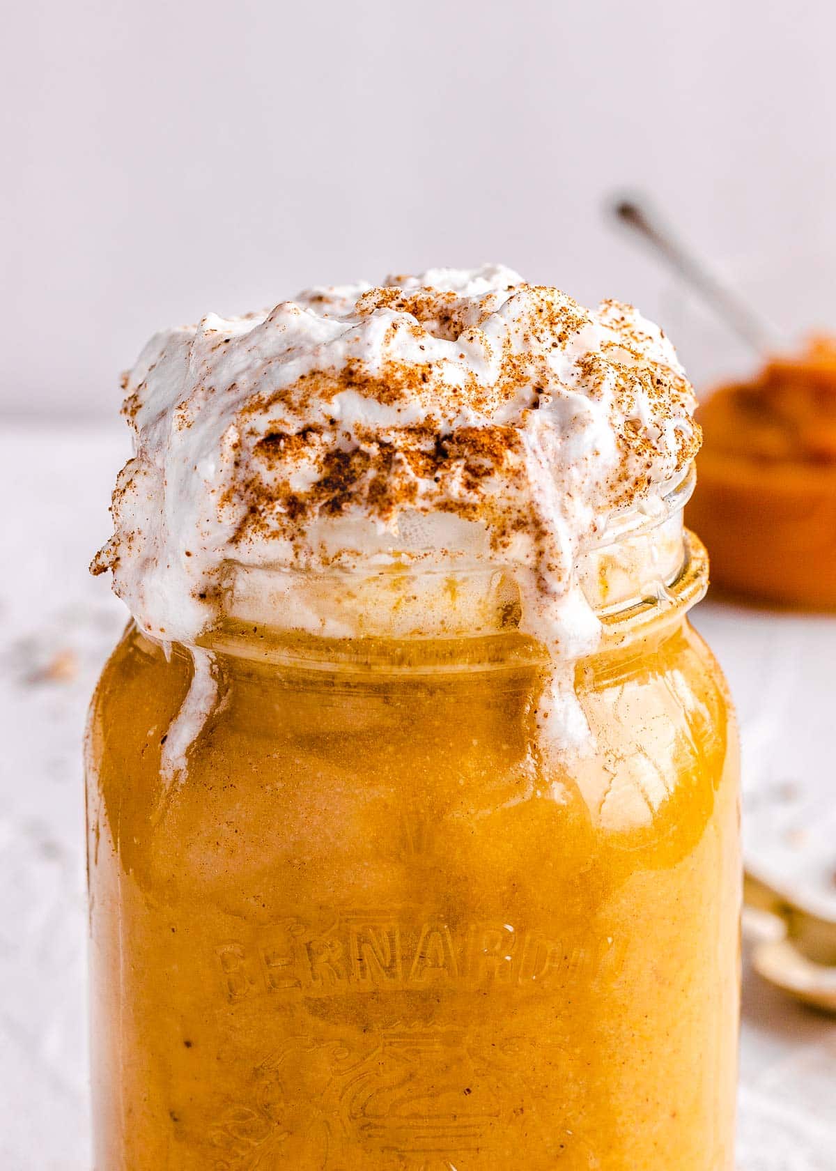 Iced pumpkin spice latte with whipped coconut cream.