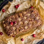 Classic Vegan Nut Roast on baking parchment decorated with cranberries.