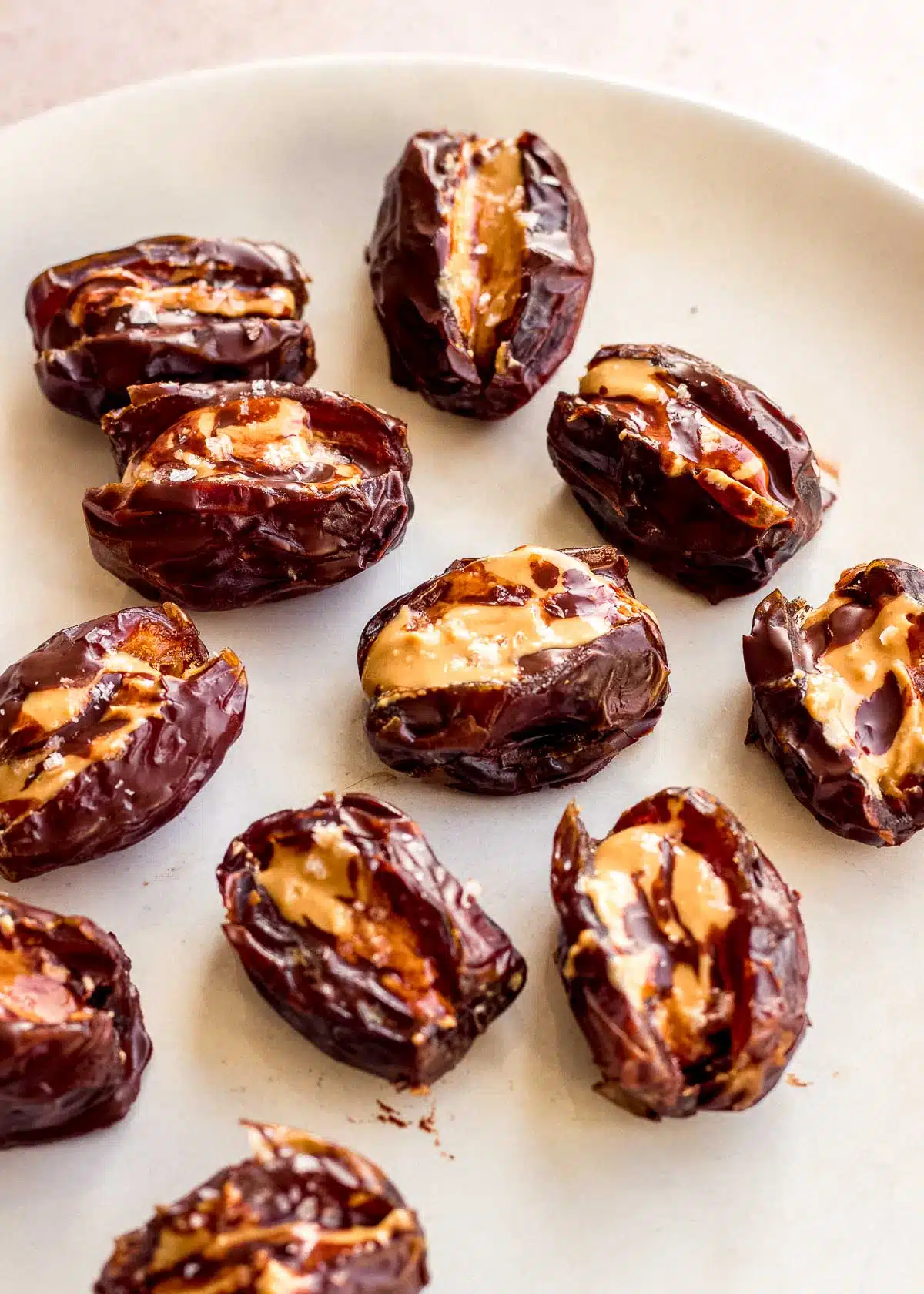 Stuffed dates with peanut butter and chocolate on a plate.