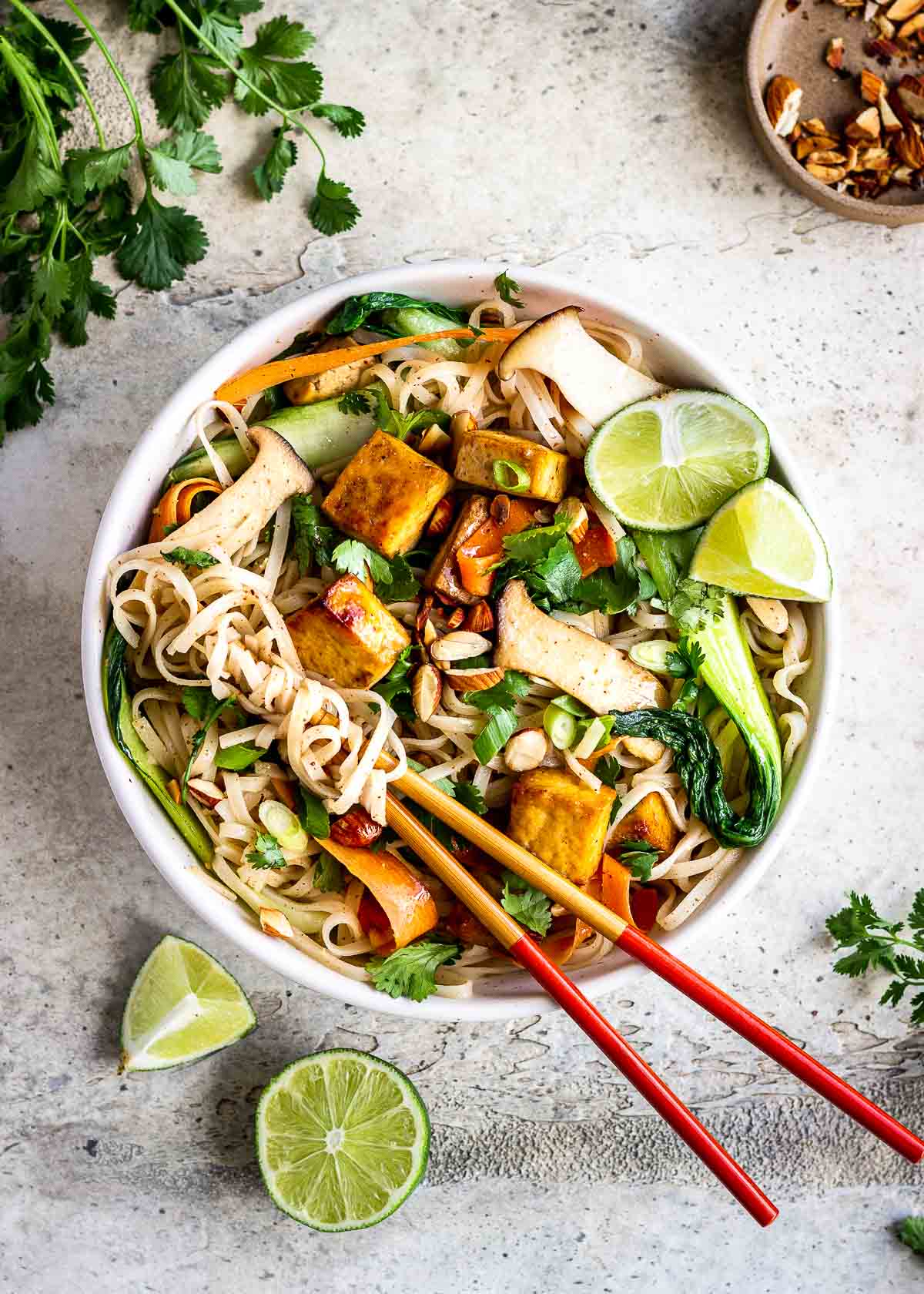 A bowl of tofu vegan noodles with almond butter and vegetables.