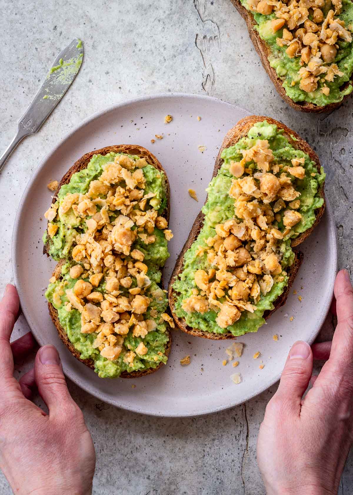 Vegan high protein avocado toast topped with chickpeas.