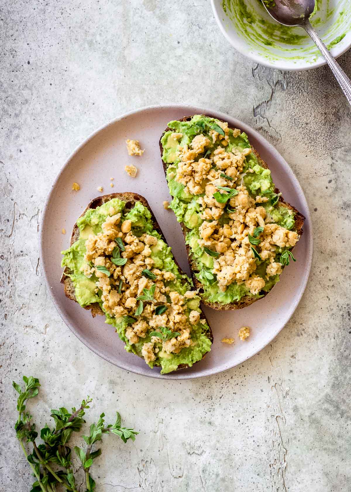 High protein vegan avocado toast with chickpeas, pea shoots and sprouts.