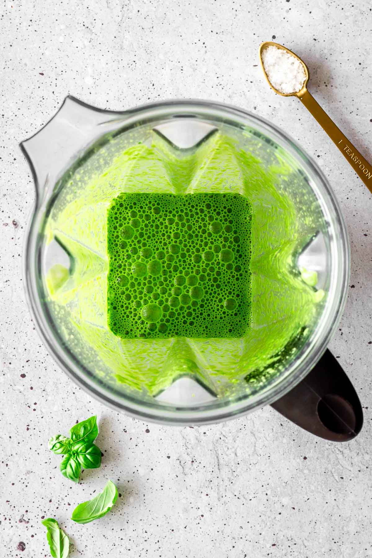 Green vegan spinach pasta sauce in a blender.