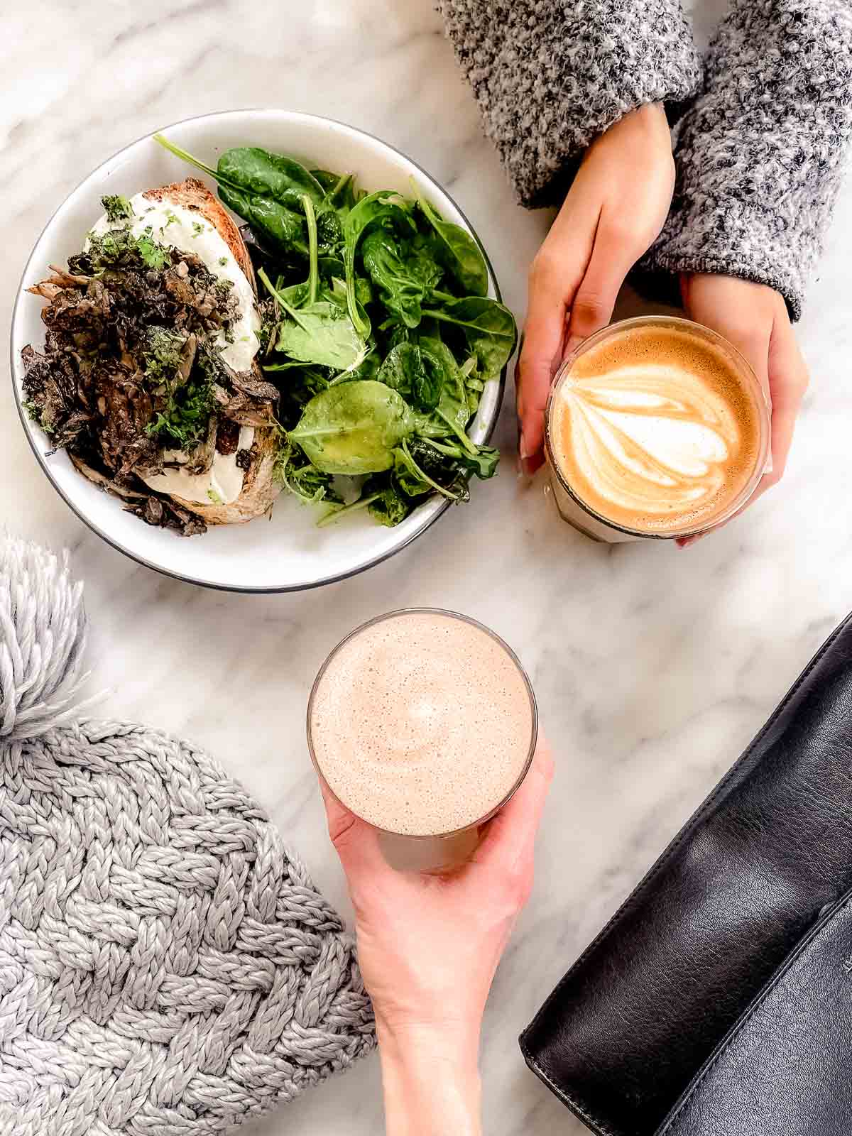 25 Best Vegan Restaurants in Vancouver BC for 2023 - mushroom ricotta toast and hands holding lattes from TurF
