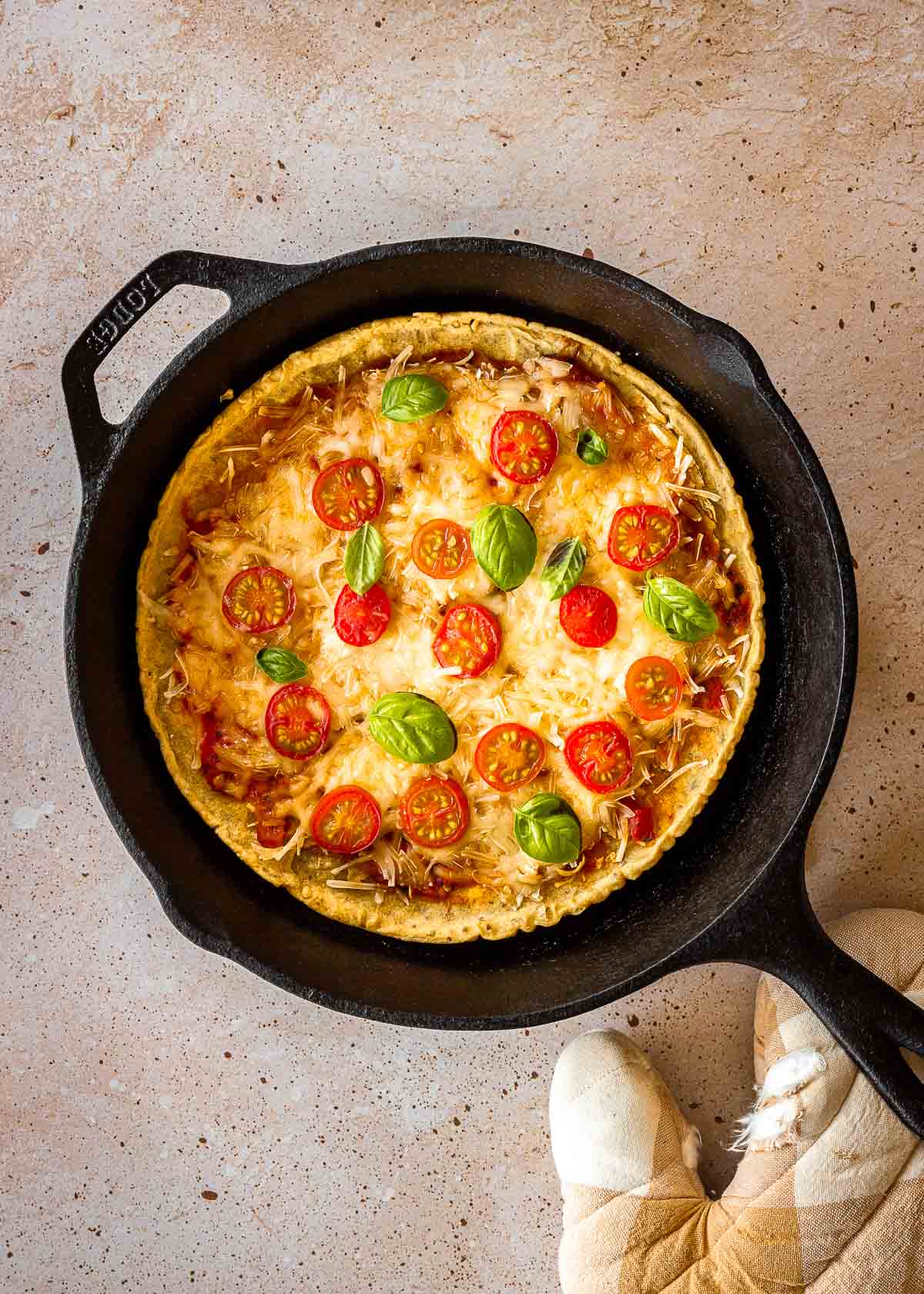 Cooked chickpea flour pizza in cast iron pan.