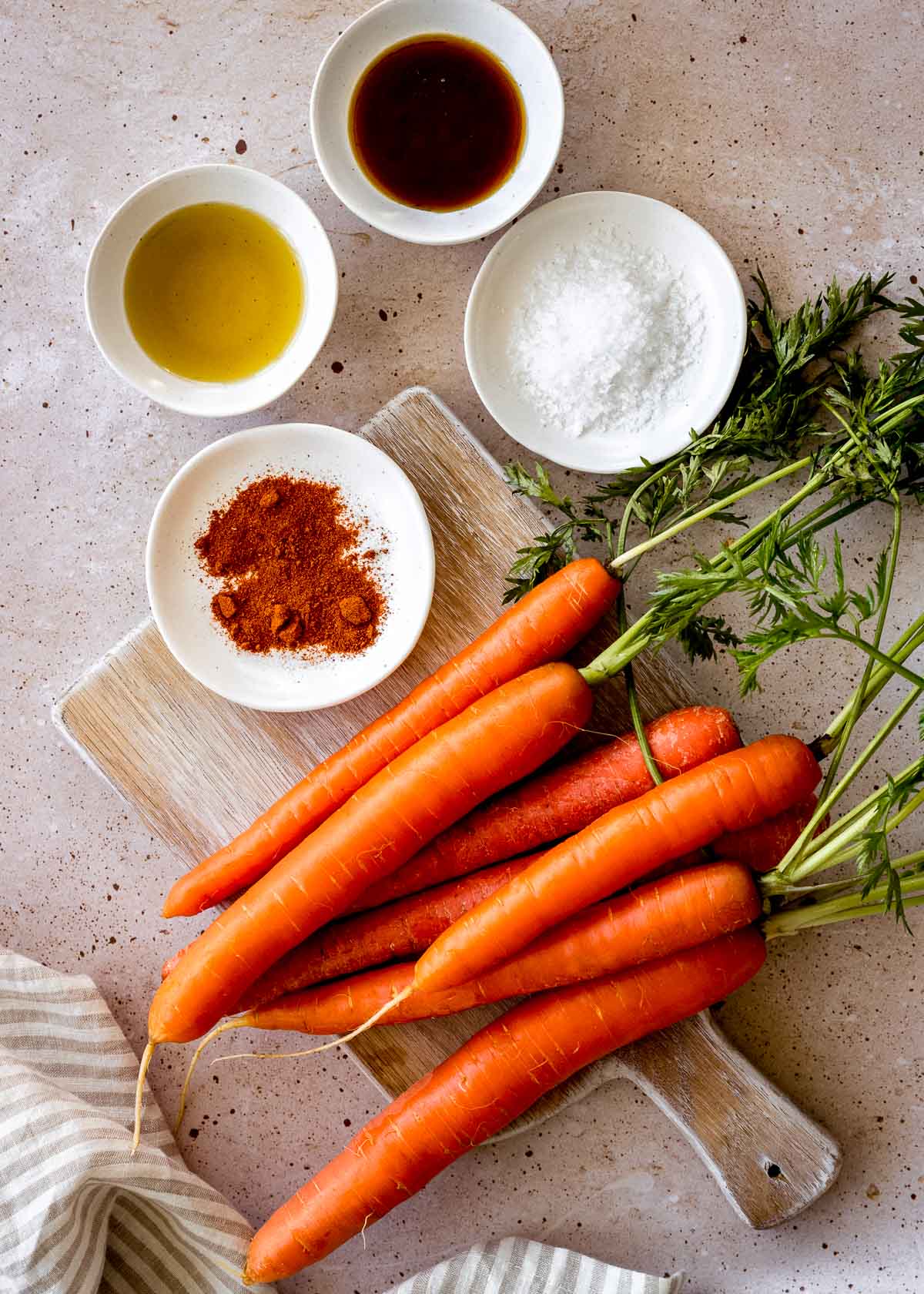 Ingredients to make maple syrup roasted carrots: carrots, cayenne pepper, sea salt, olive oil and maple syrup.