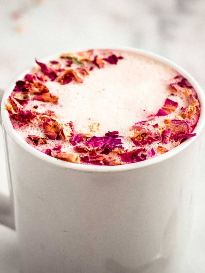 Rose latte decorated with rose petals.