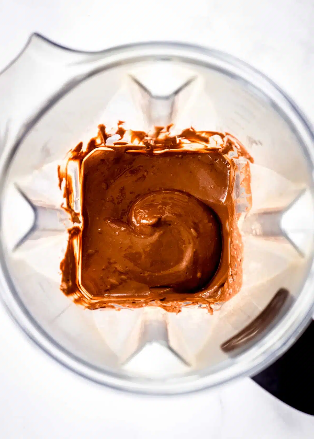 A blender full of chocolate mousse with avocados.